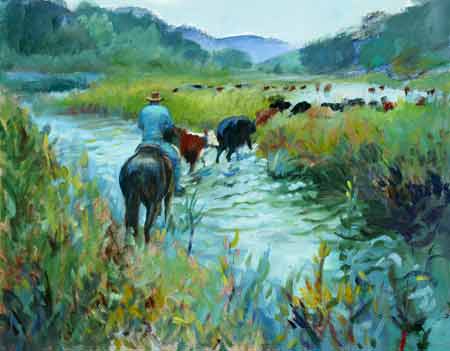 The cowboy trailing the cattle as the pass thru the wet and lush river area.
