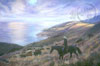 A lone cowboy is riding down a ridge toward the cattle as the drift along the hillside toward the very calm ocean shore. The ocean is reflecting the purple blue shades of the sky and the the hillside is a yellow dry grass color with occational green brush. 