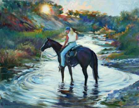 The cowgirl rests her horse in the creek, were the horse drinks happily. 
