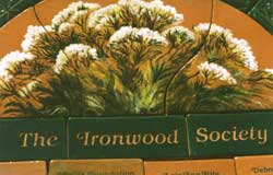 A tile painting of wild plants, with the title, The Ironwood Society.